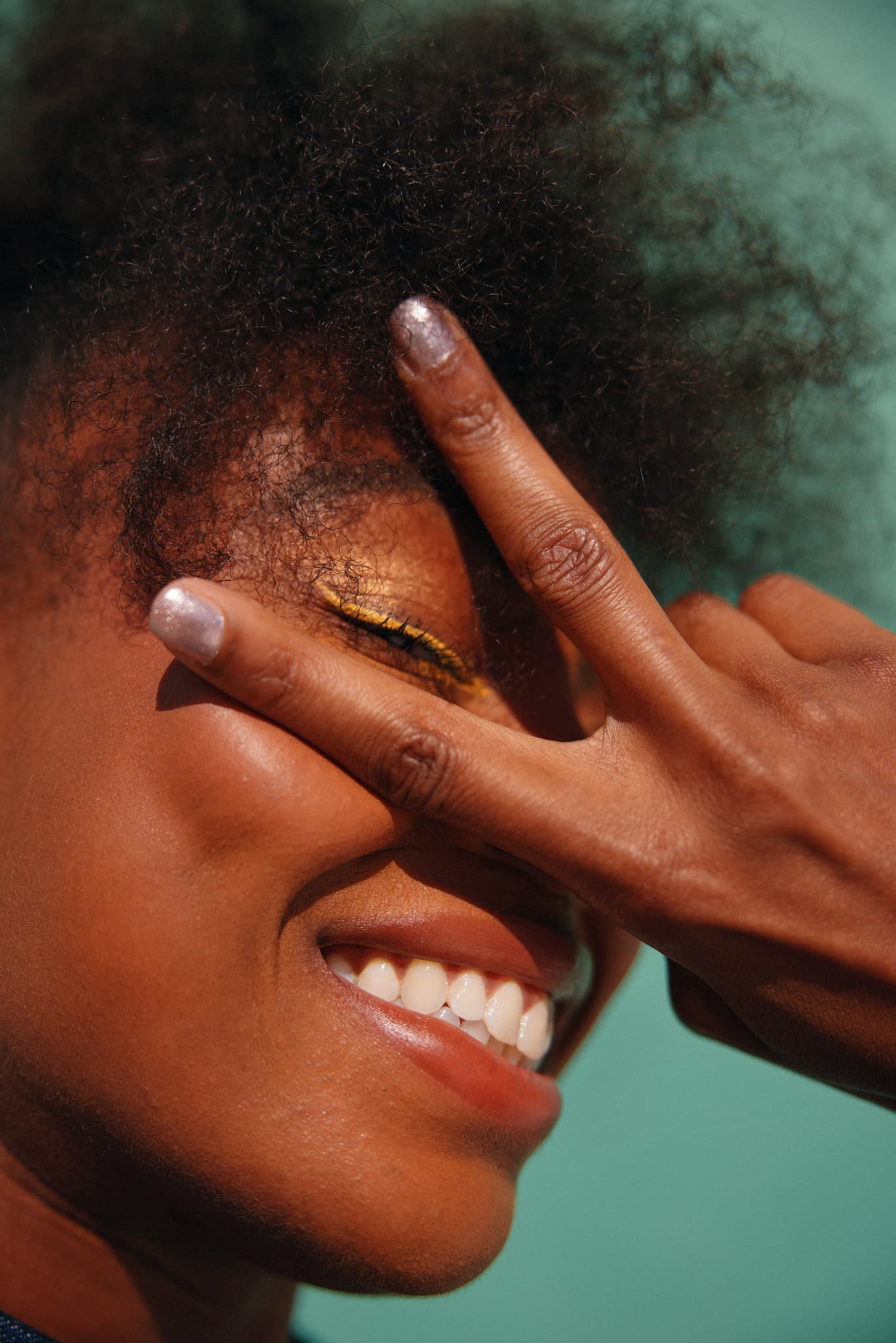 woman with peace sign over her eyes (1366 × 2048)